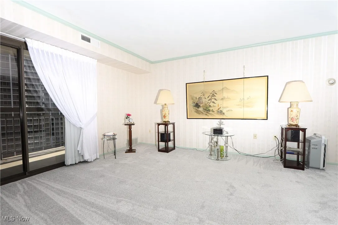 Living area with carpet flooring and baseboards
