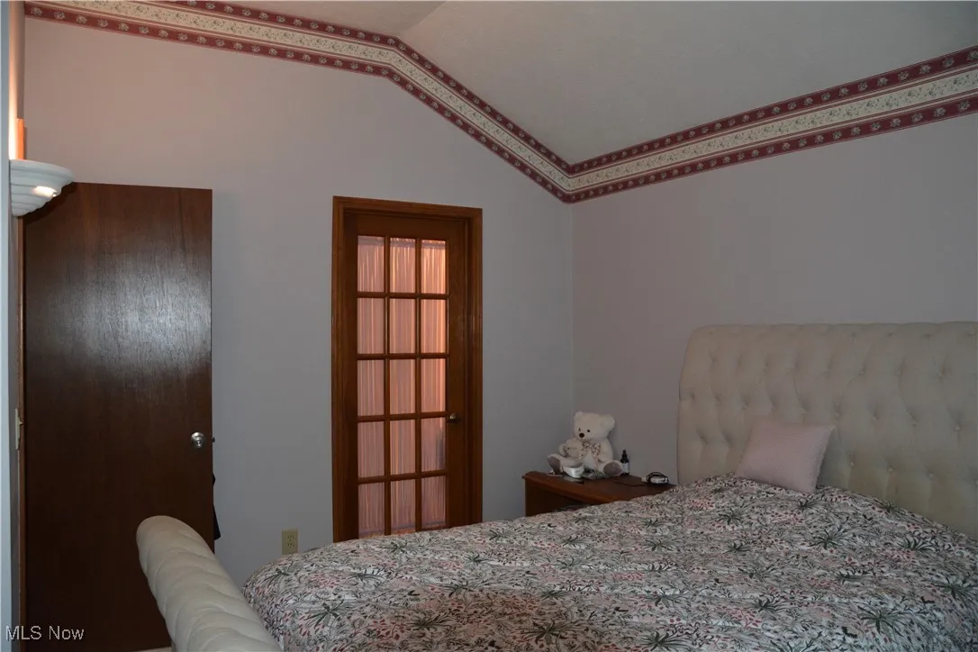 Bedroom featuring lofted ceiling