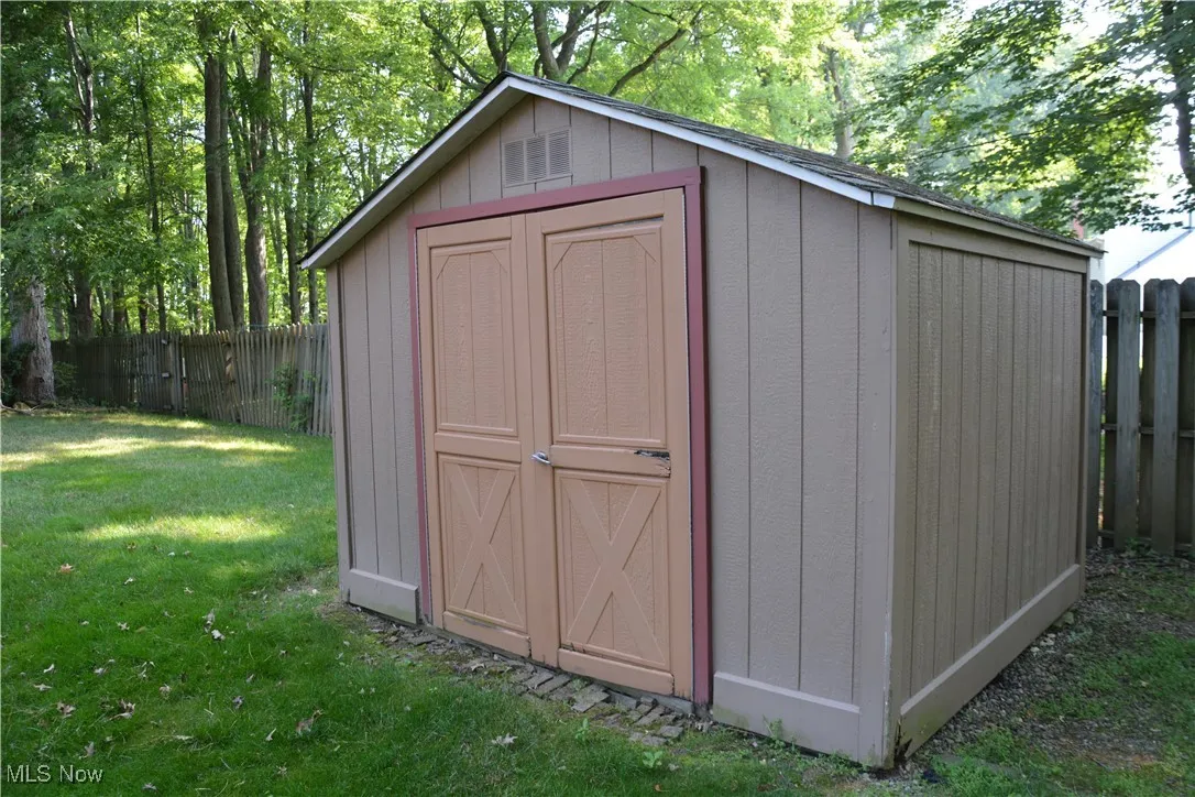 View of shed with a fenced backyard
