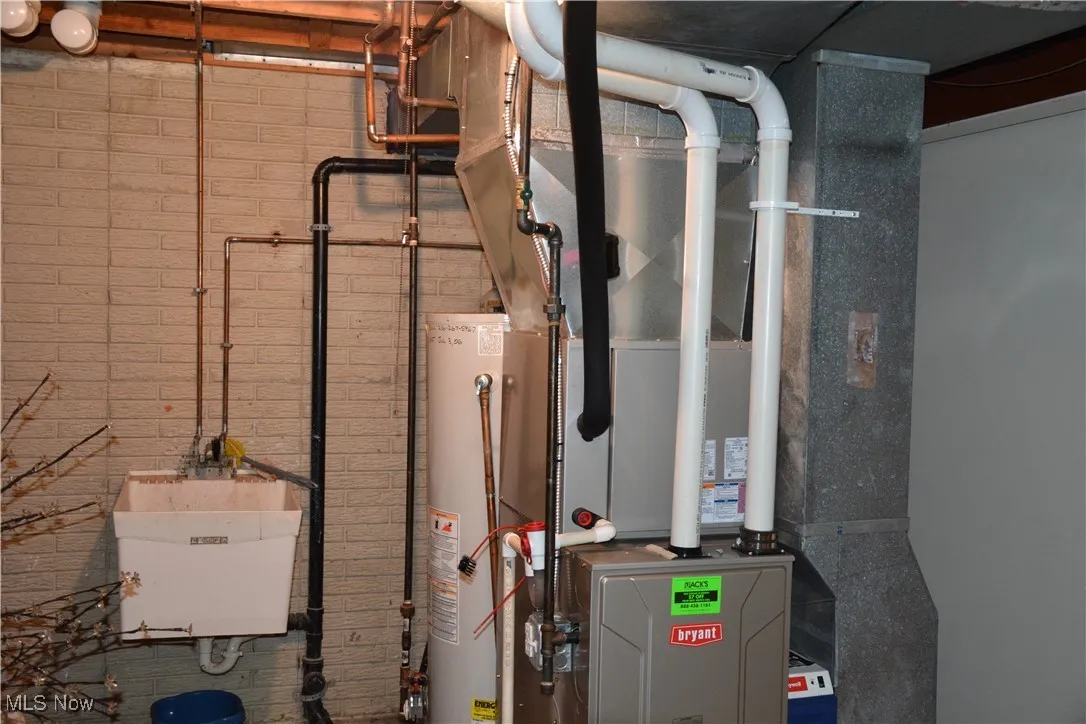 Utilities with gas water heater and a sink