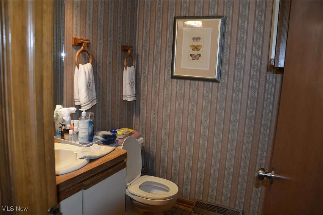Full bathroom with vanity and tile patterned flooring