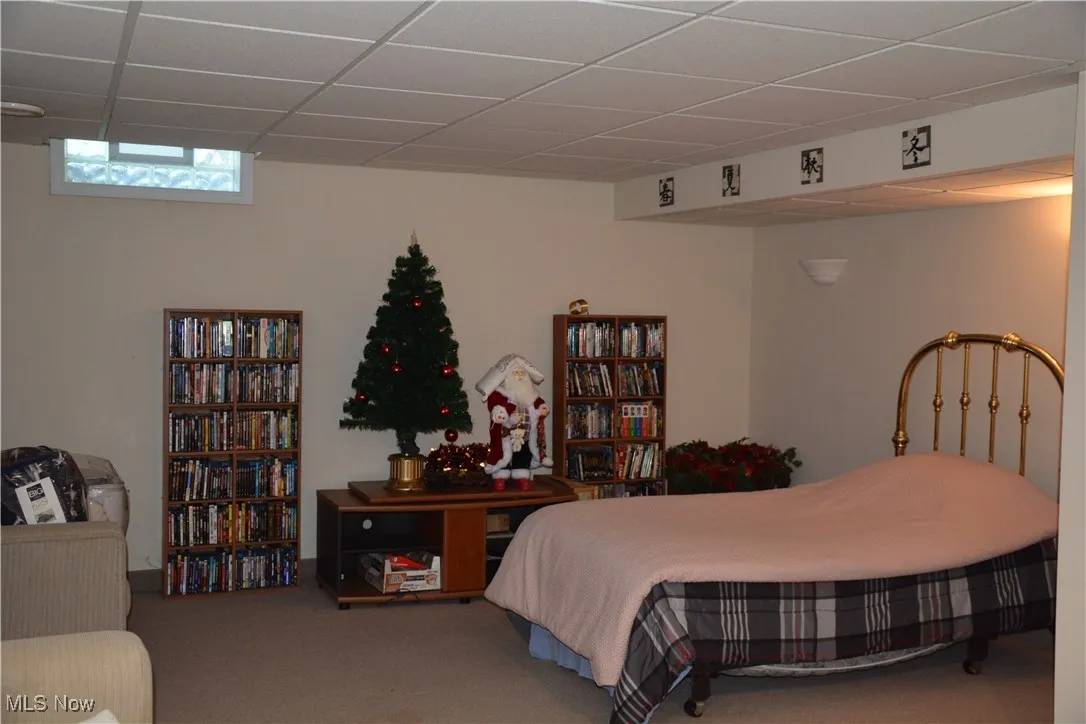 Bedroom featuring carpet floors and a paneled ceiling