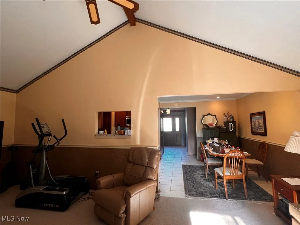 Lower level Living area with light colored carpet, a drop ceiling, and recessed lighting