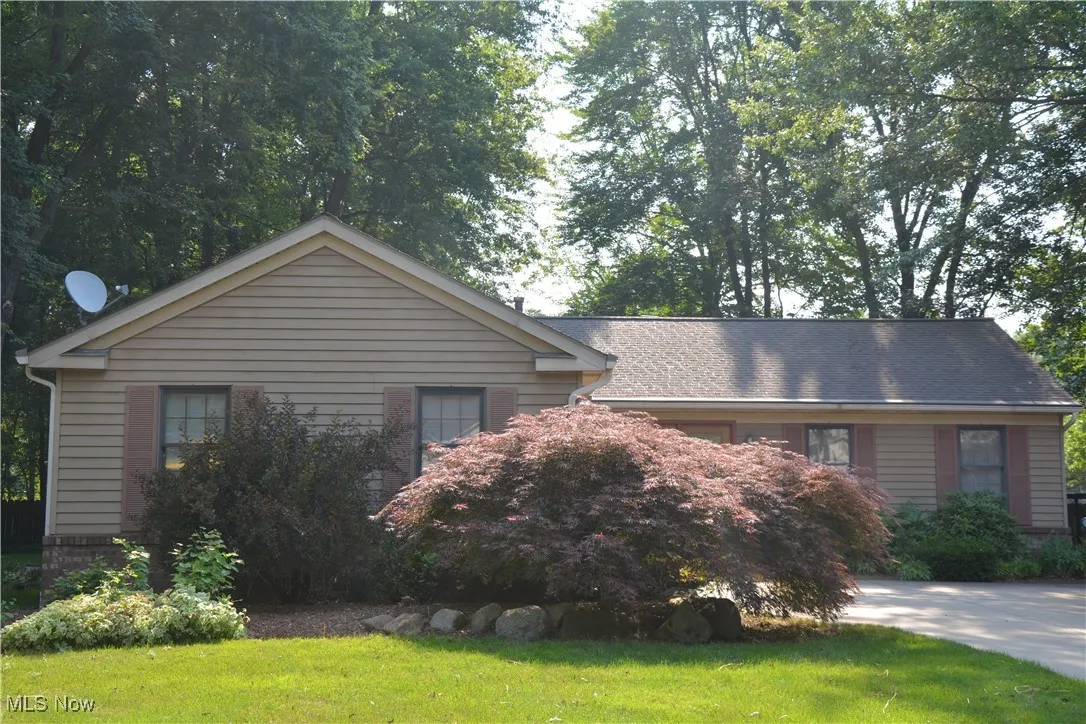 View of property exterior with a lawn