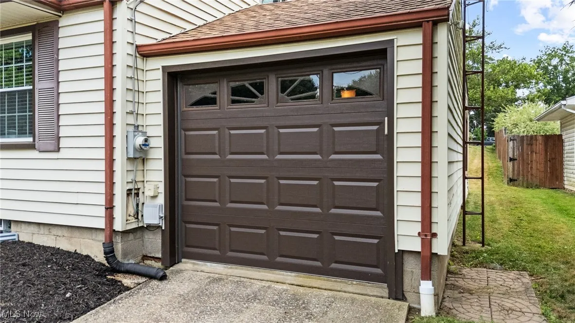 Attached Garage featuring driveway