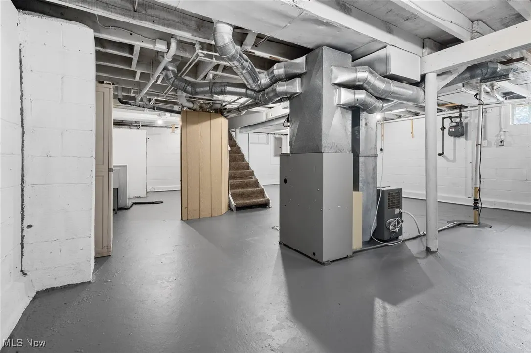Basement with stairway and heating unit