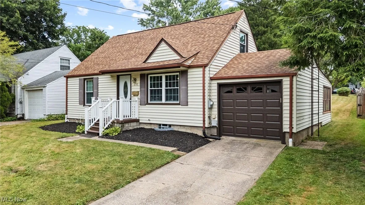 View of front of house featuring roof with shingles approx 5-6 yrs old, an attached garage, concrete driveway, and a front yard