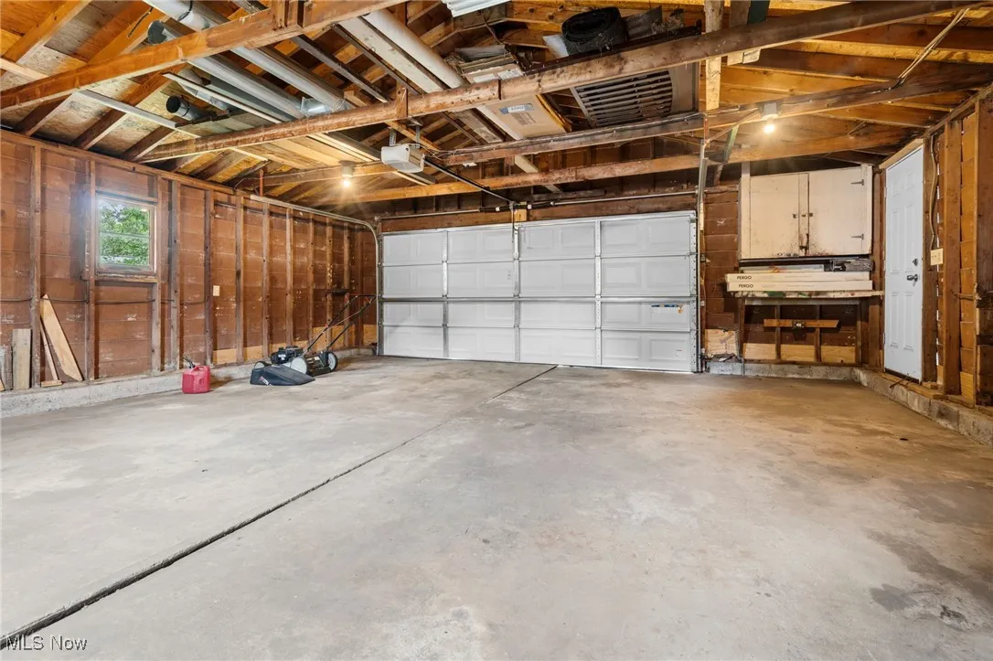 detached 2 car Garage featuring a garage door opener