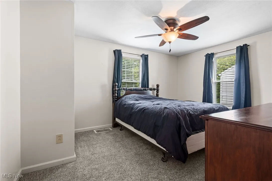 First floor Bedroom featuring carpet flooring and ceiling fan/light