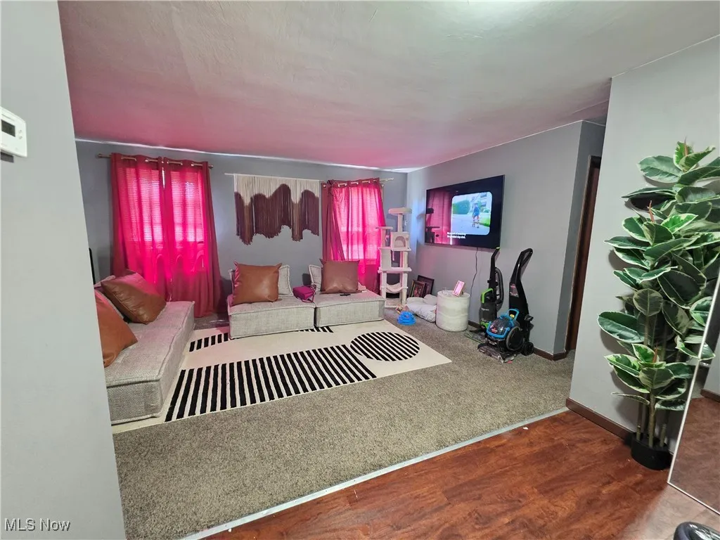 Bedroom with wood finished floors and baseboards