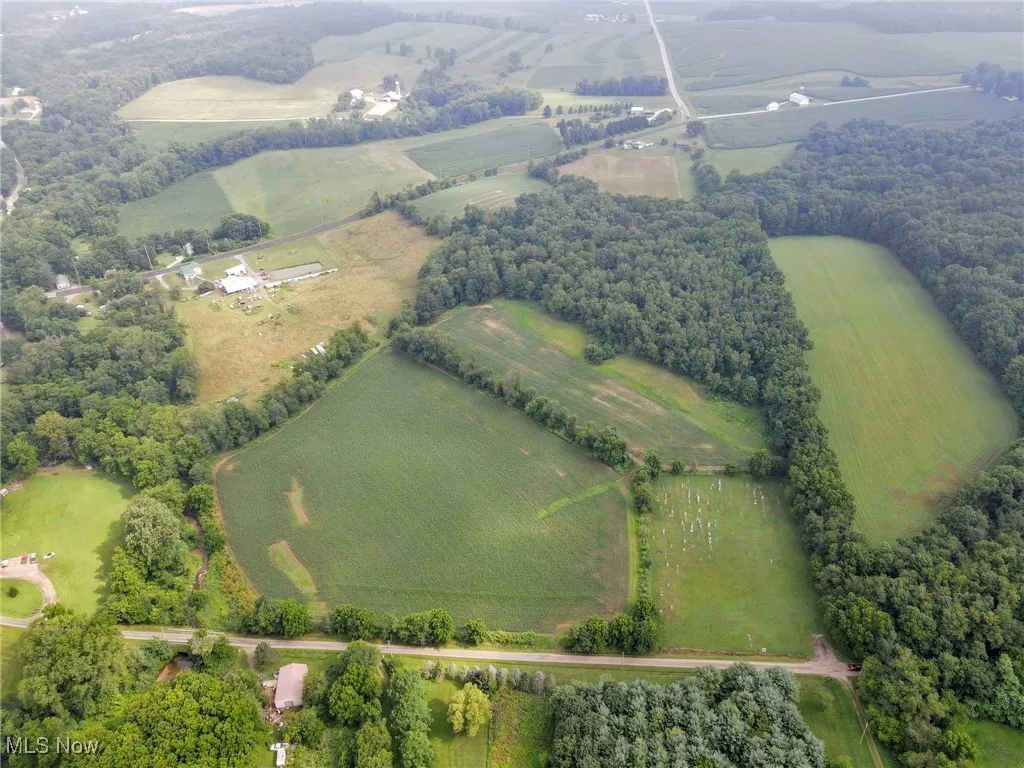 Aerial overview of property's location with rural landscape and large plots for crops