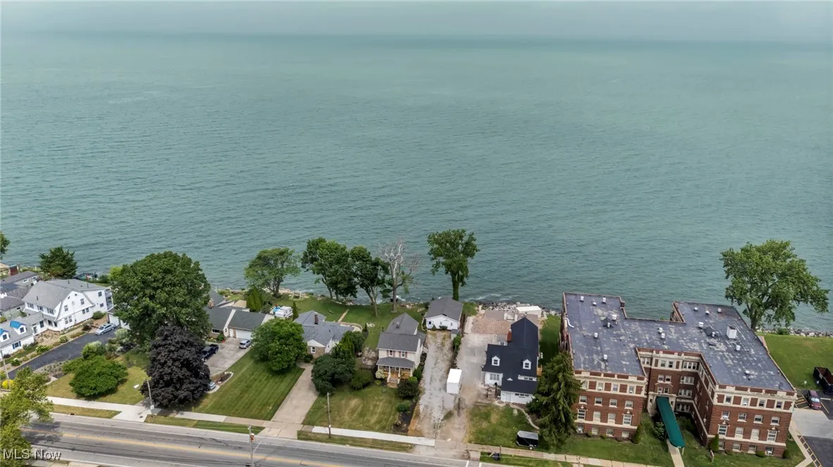 View of property location with a large body of water and nearby suburban area