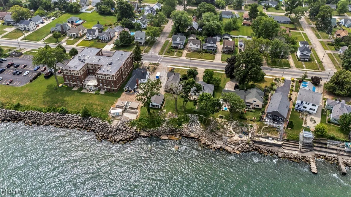 Aerial view of property's location with nearby suburban area and a large body of water