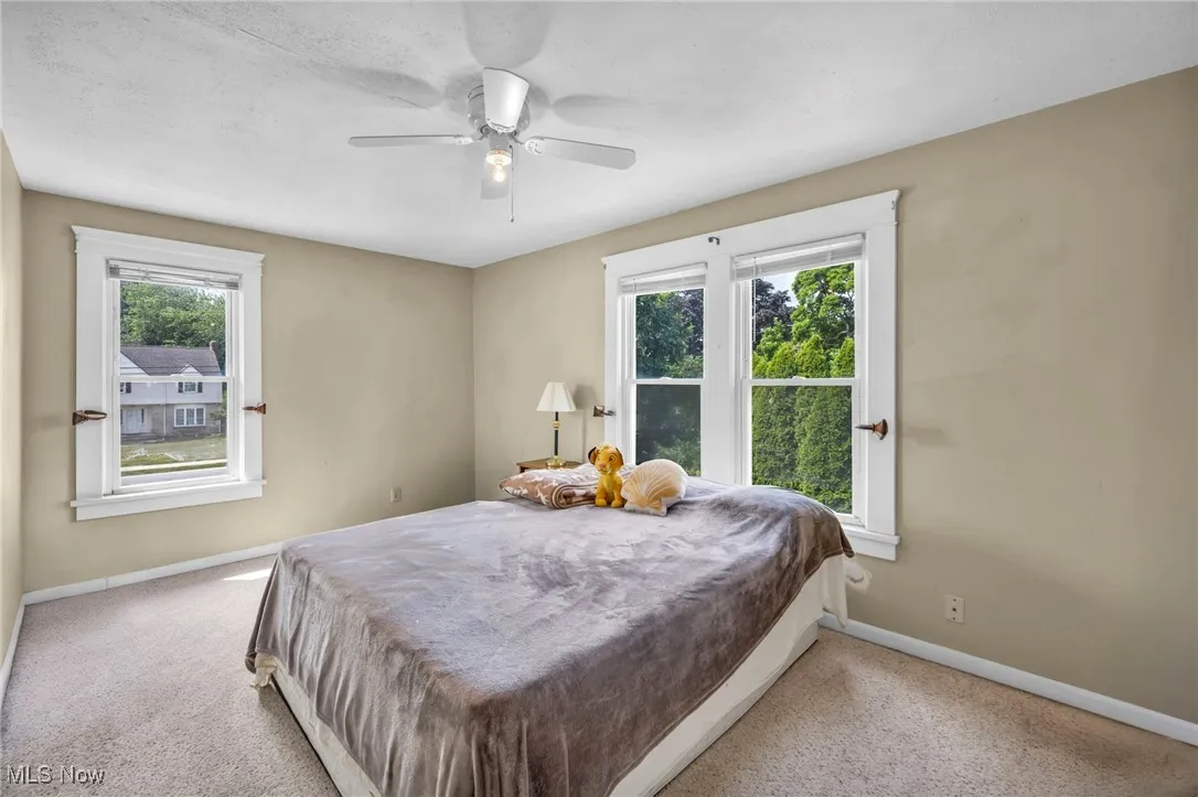 Bedroom with carpet and a ceiling fan