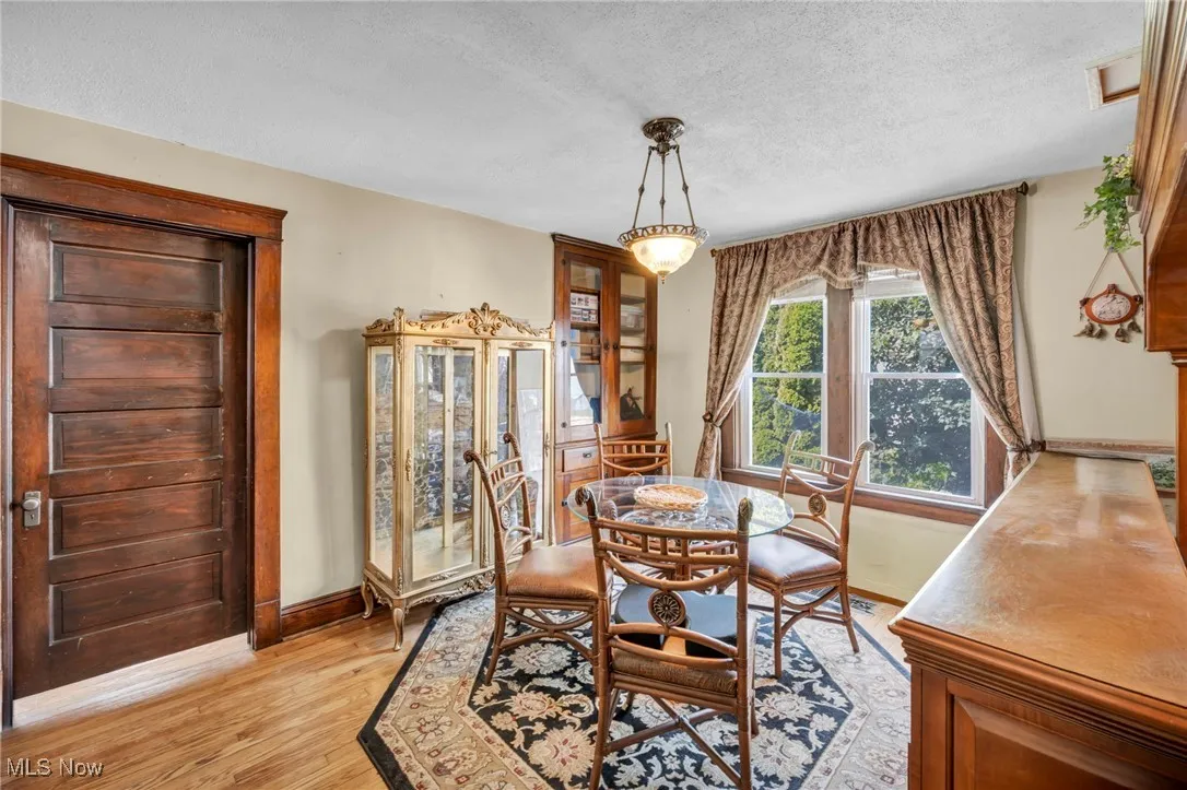 Dining room with a textured ceiling and light wood-style floors