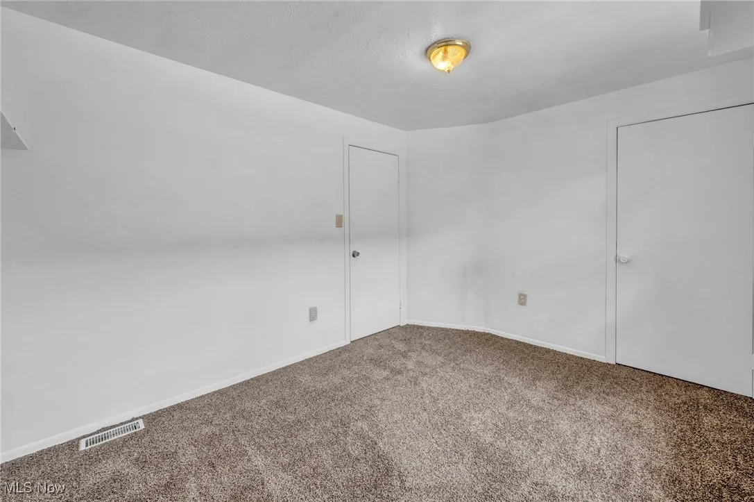 Unfurnished room with carpet and baseboards