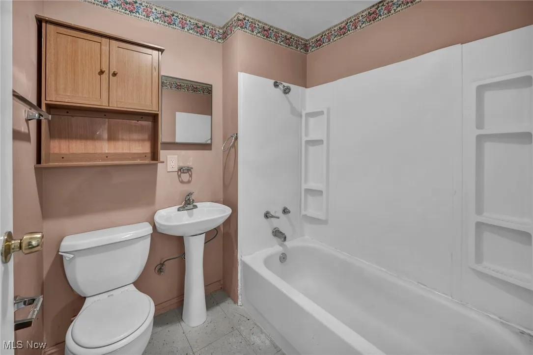 Bathroom featuring toilet and tub / shower combination