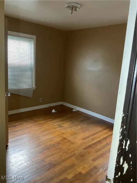 Empty room featuring hardwood / wood-style floors