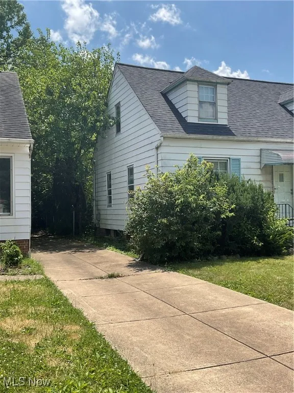 View of property exterior with roof with shingles