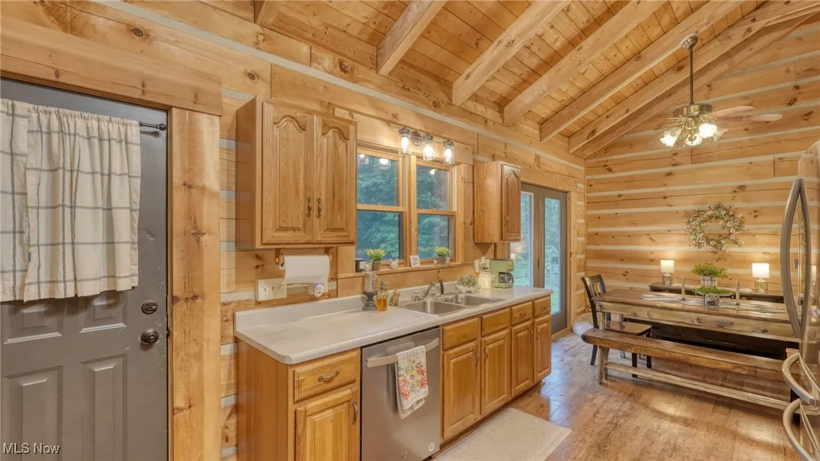 Kitchen featuring wooden ceiling, light wood-style flooring, stainless steel appliances, light countertops, and ceiling fan