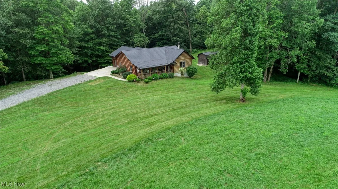 View of subject property with a heavily wooded area