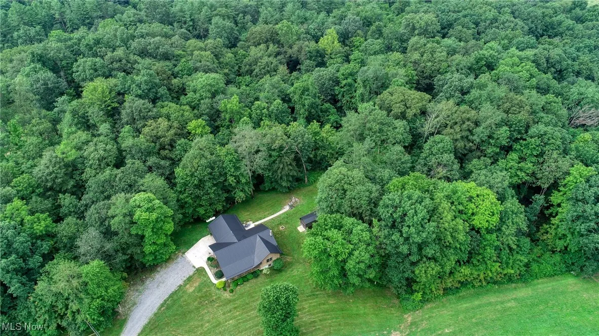Aerial overview of property's location featuring a heavily wooded area