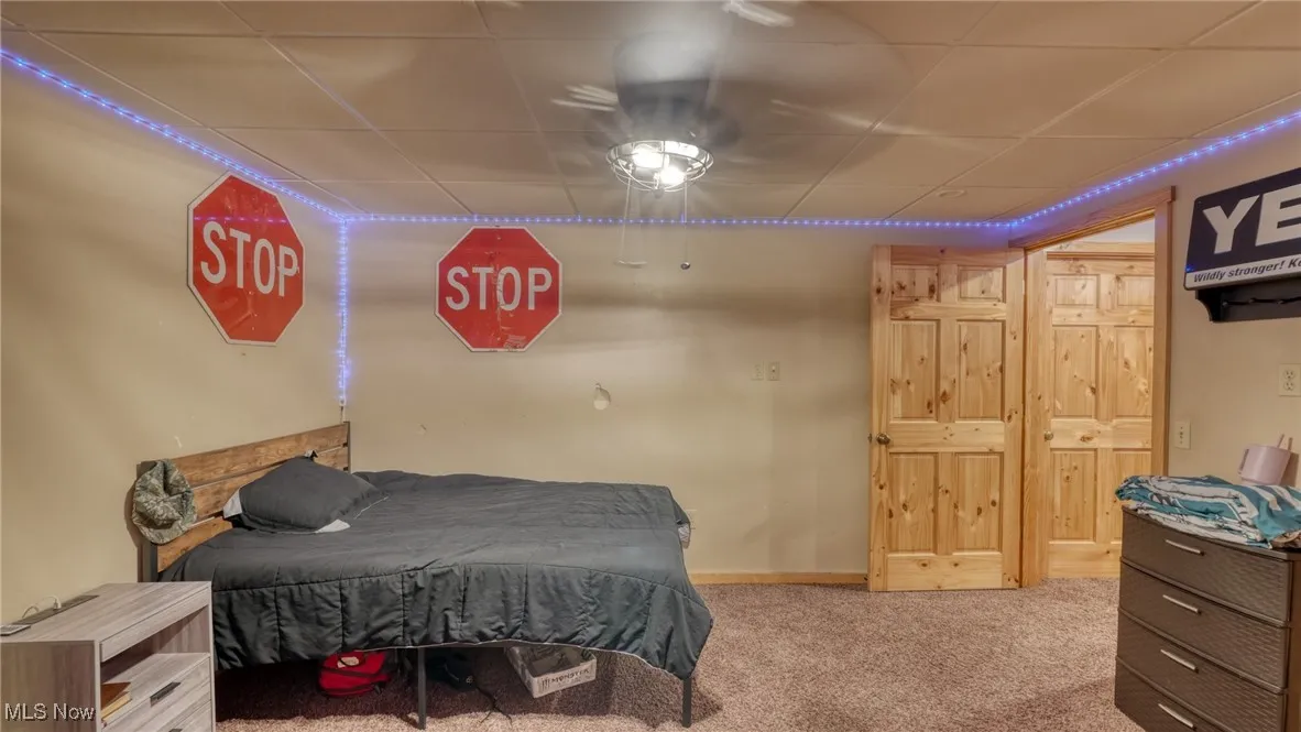 Carpeted bedroom with a drop ceiling