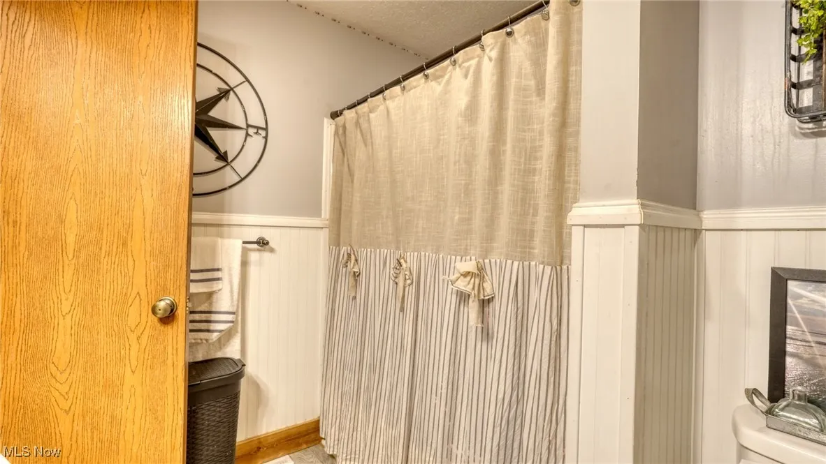 Bathroom featuring a wainscoted wall