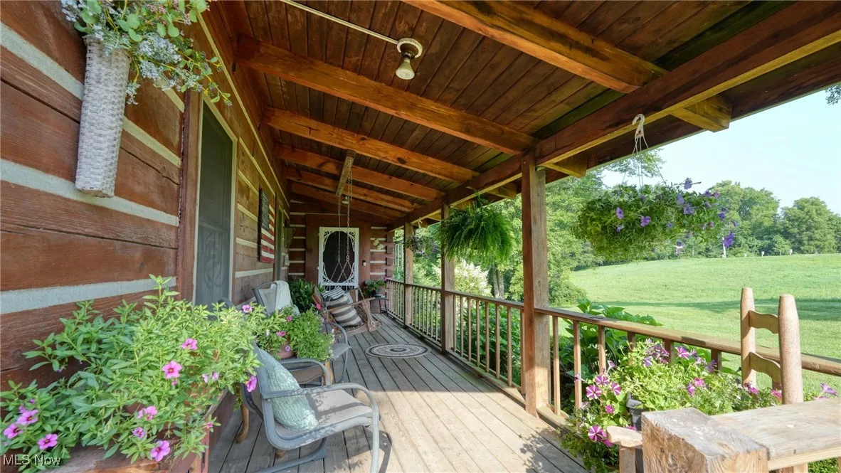 Wooden porch featuring a yard