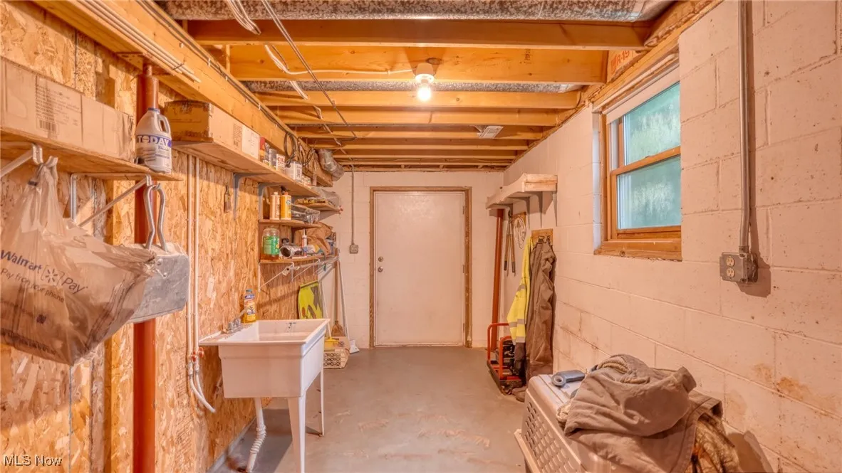 Below grade area featuring concrete block wall