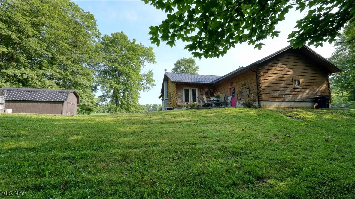 View of green lawn featuring a shed