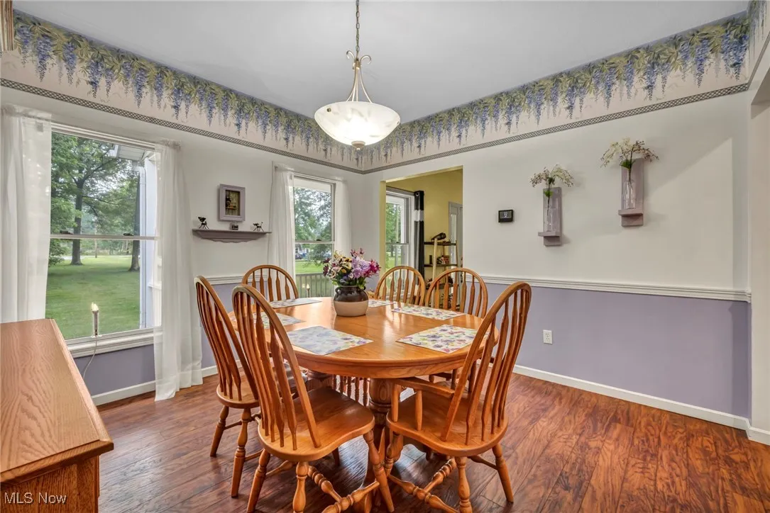 Dining space featuring wood finished floors and baseboards