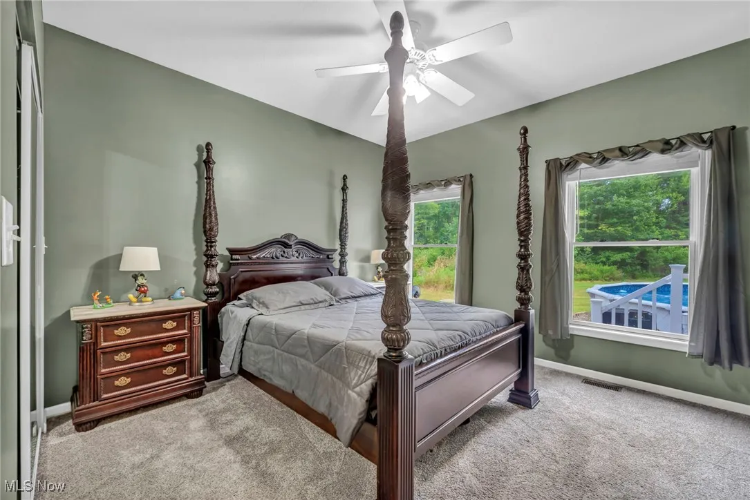 Bedroom featuring light colored carpet and ceiling fan