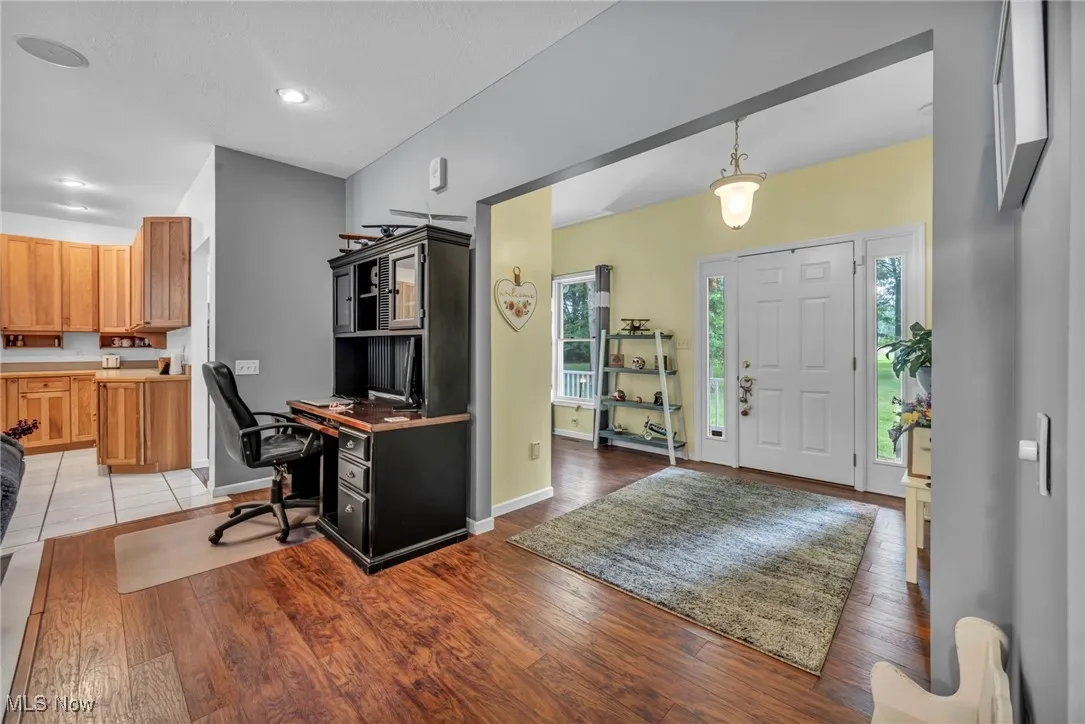 Entrance foyer with light wood-style floors and recessed lighting