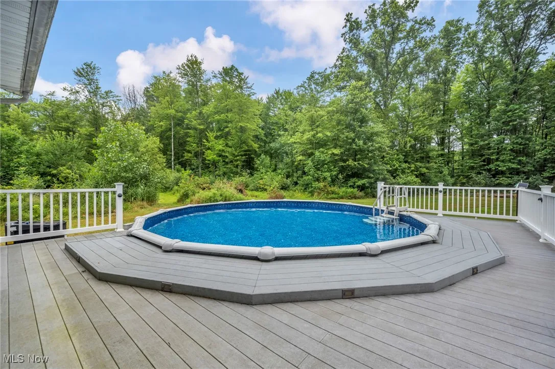 Outdoor pool featuring a wooden deck
