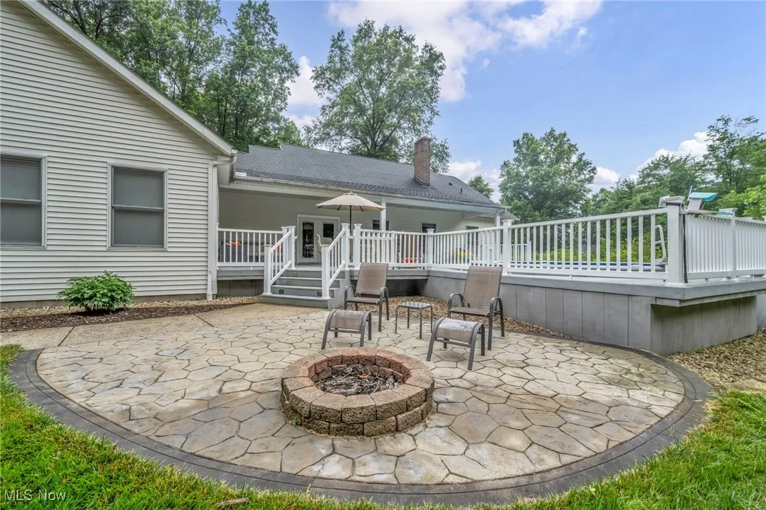View of patio / terrace featuring an outdoor fire pit and a wooden deck