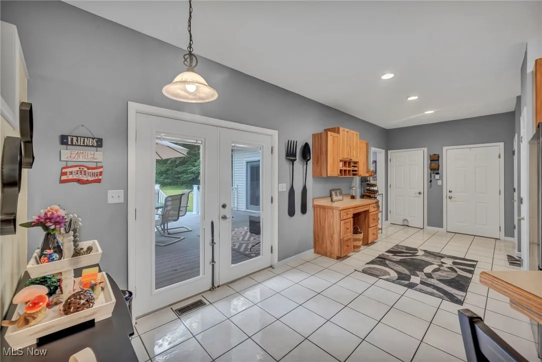 Entryway with french doors, recessed lighting, and light tile patterned flooring