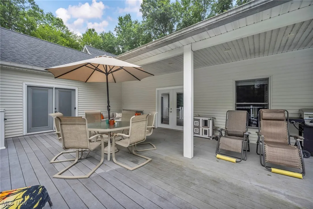Deck featuring outdoor dining area, french doors, and grilling area