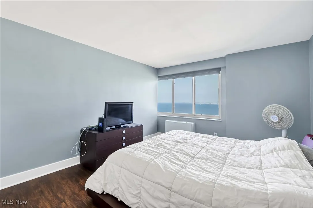 Bedroom with baseboards and wood finished floors