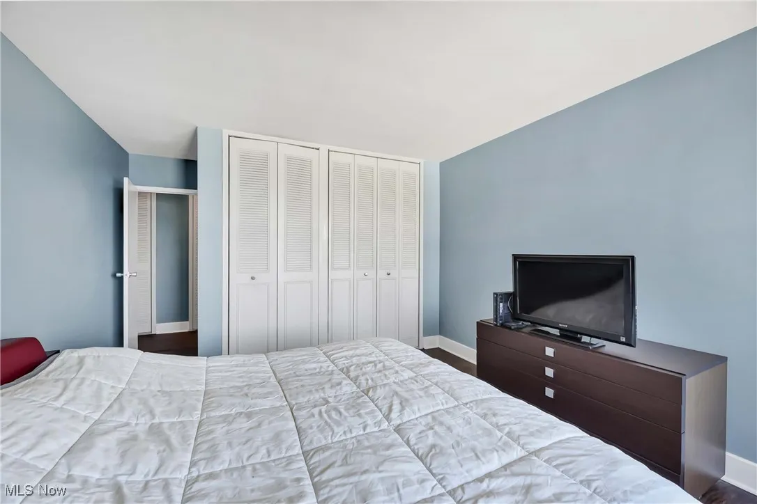 Bedroom featuring two closets and wood finished floors