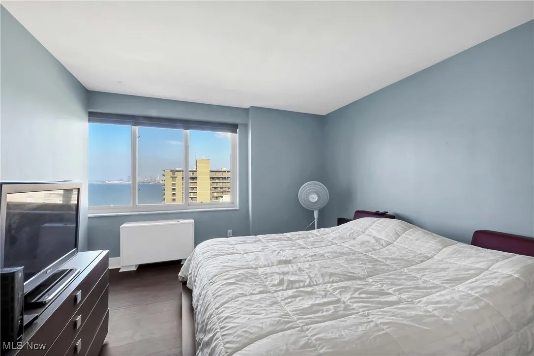 Bedroom featuring radiator and baseboards