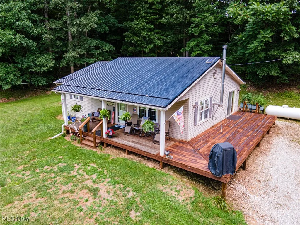 Wooden terrace with a lawn and a grill
