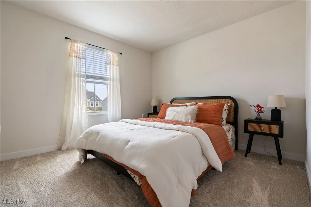 Carpeted bedroom with baseboards