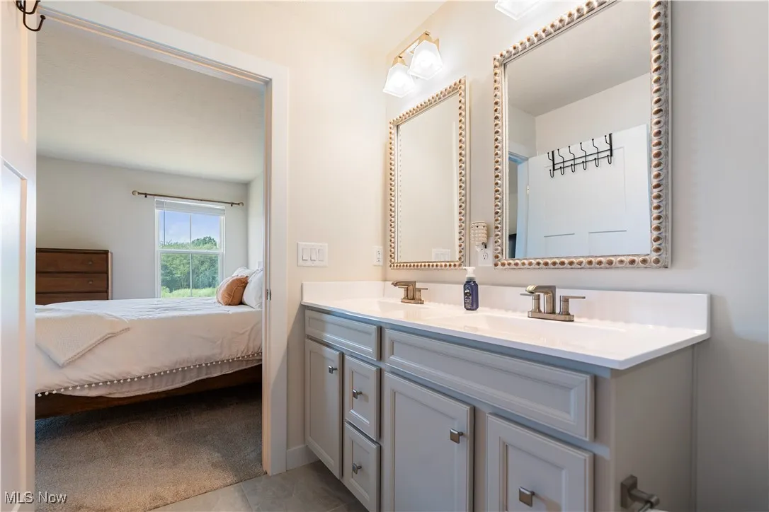 Ensuite bathroom featuring double vanity