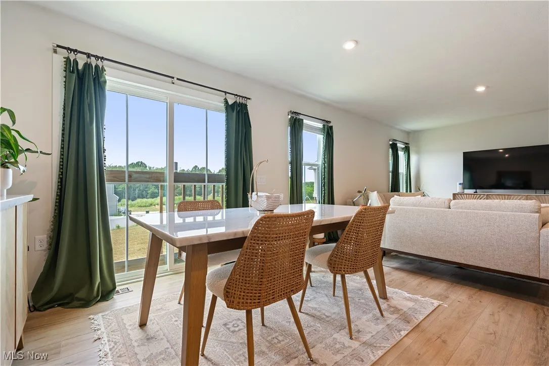 Dining area featuring light wood finished floors and recessed lighting