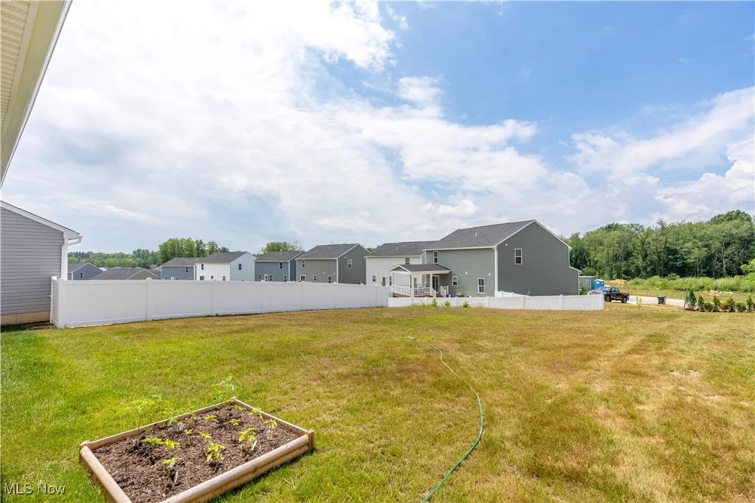 View of yard with a vegetable garden and a residential view