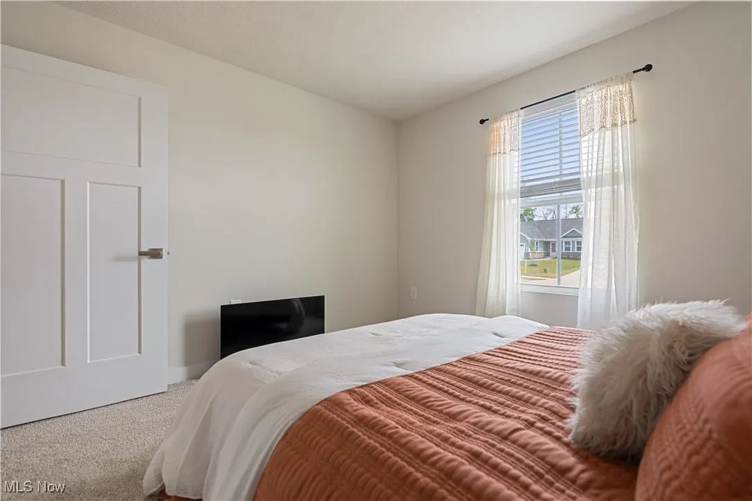 Carpeted bedroom with baseboards