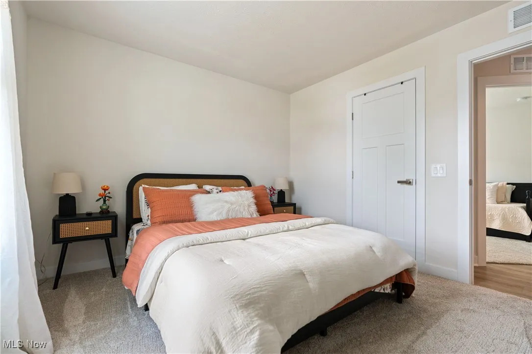 Carpeted bedroom featuring baseboards
