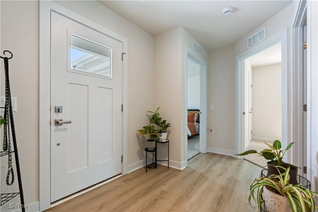 Entryway with light wood-style floors and baseboards