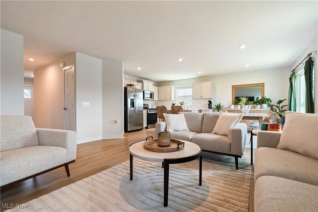 Living area featuring light wood-style floors and recessed lighting